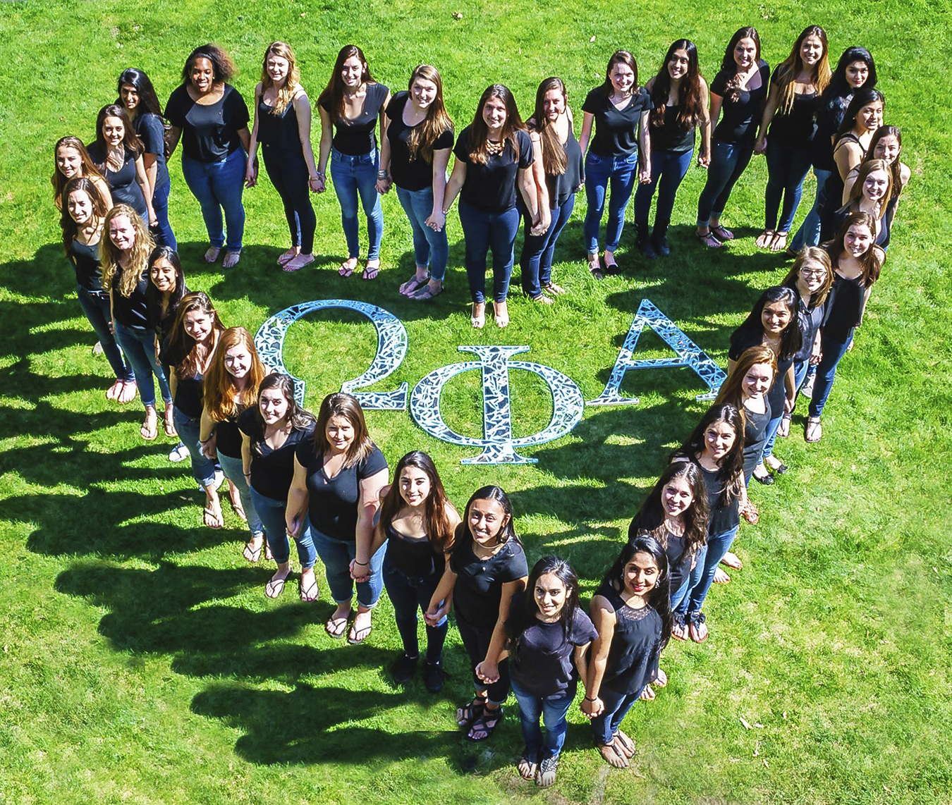 sisters standing in heart shape